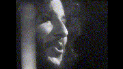 a black and white photo of a woman 's face in a dark room
