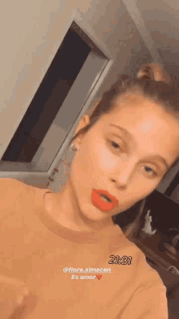 a woman with red lipstick is taking a selfie with the time 21:31