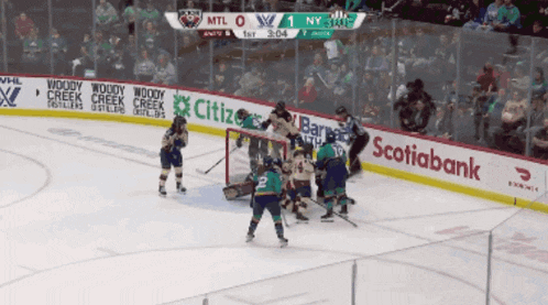 a hockey game is being played in a stadium with advertisements for citibank and scotiabank