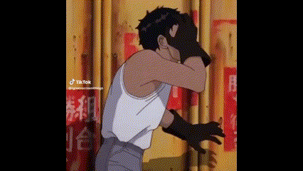 a man in a white tank top is covering his face with his hands .