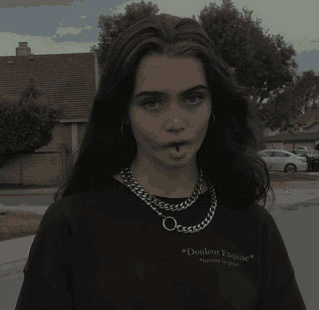 a girl wearing a t-shirt that says douleur exquise