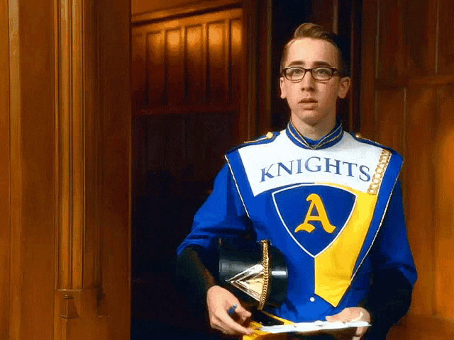 a man in a knights uniform is holding a tray