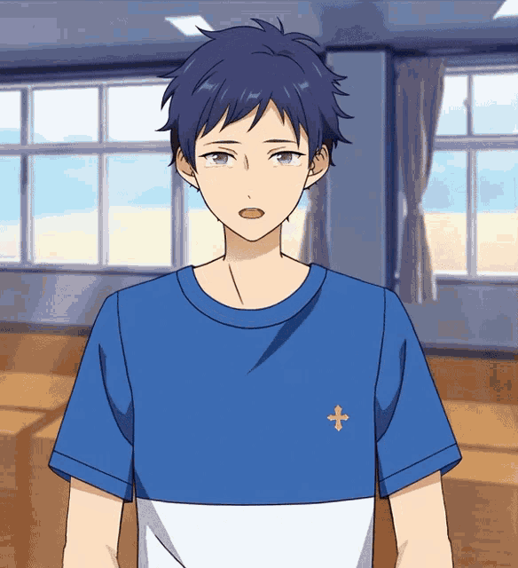 a boy wearing a blue shirt with a cross on the front