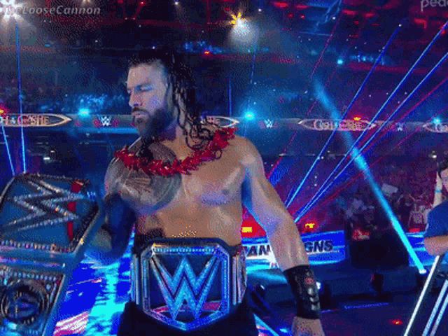 roman reigns is the wwe world heavyweight champion and is wearing a lei around his neck