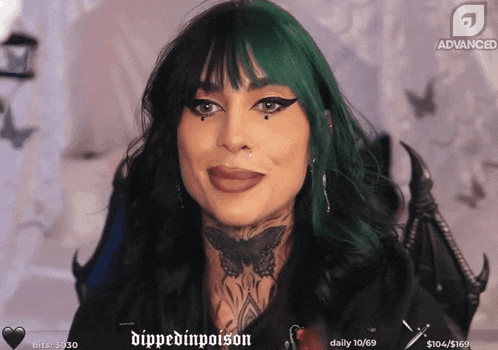 a woman with green hair and a tattoo on her neck is smiling