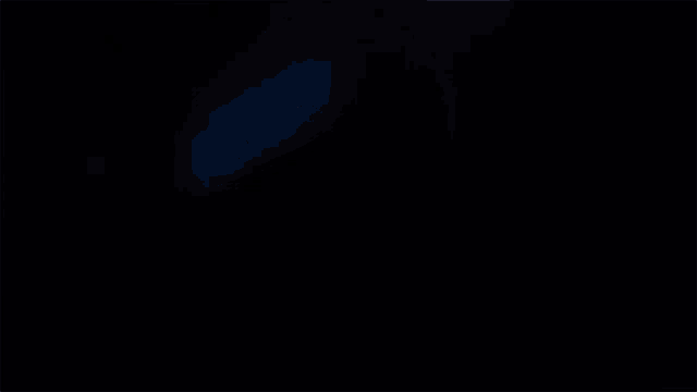 a cartoon character with blue eyes looks at the camera in the dark