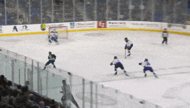 a hockey game is being played on a ice rink with a few sponsors including ao