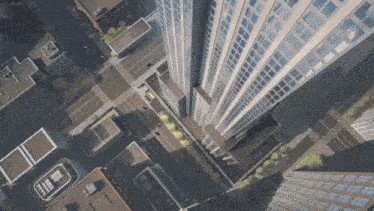 an aerial view of a city with a helicopter on the roof of a building