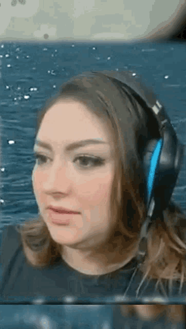 a close up of a woman wearing headphones and a microphone .