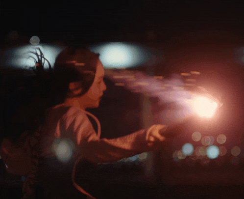 a person is holding a torch in their hand in the dark
