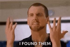 a man is making a funny face and saying `` i found them '' .
