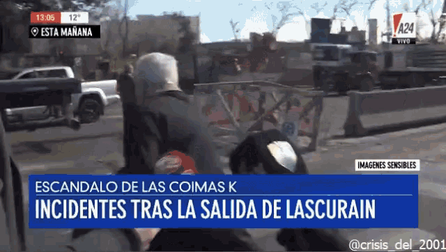 a television screen shows a man walking down a street and the words " escandalo de las coimas k "