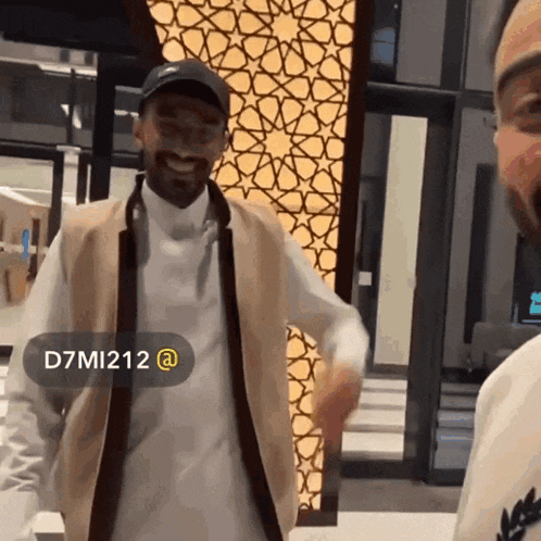 two men are standing next to each other and one of them has the username d7mi212