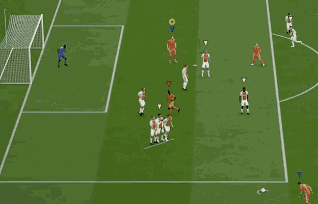 a soccer game is being played on a green field with a yellow circle in the middle
