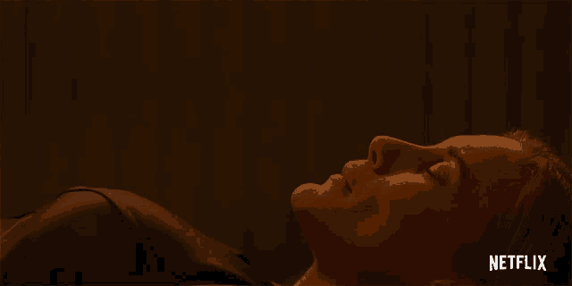 a close up of a woman laying down with netflix written on the bottom