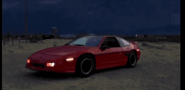 a red sports car is driving down a dirt road with lightning behind it .