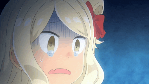 a cartoon girl with blonde hair and a red bow on her head is crying