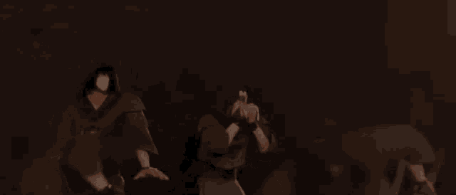 a man is holding a gun in a dark room while another man is holding a sword .