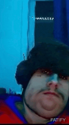 a man with a beard wearing a hat with fatify written in the corner