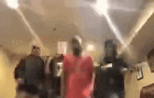 a blurry picture of a group of people dancing in a living room .
