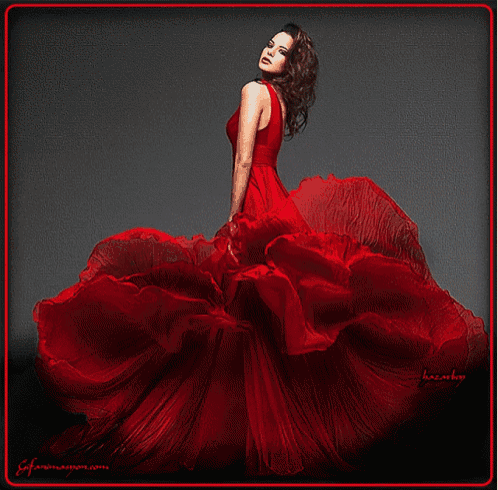a woman in a long red dress is standing in front of a black background