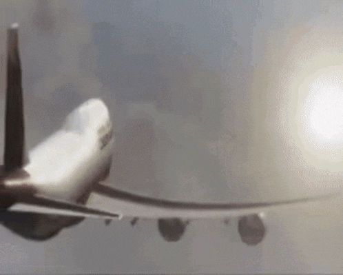 a plane is flying through the air with the sun shining through the clouds
