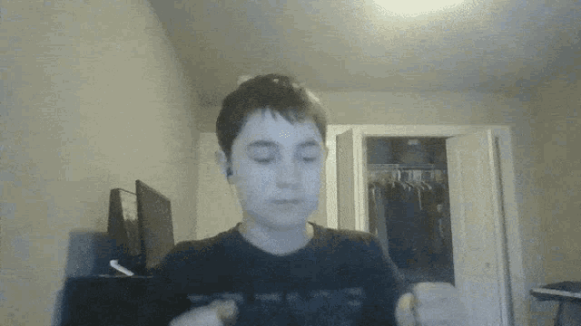 a young boy wearing a black shirt that says " i love you " on it