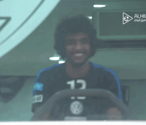 a man wearing a black shirt with the number 13 on it