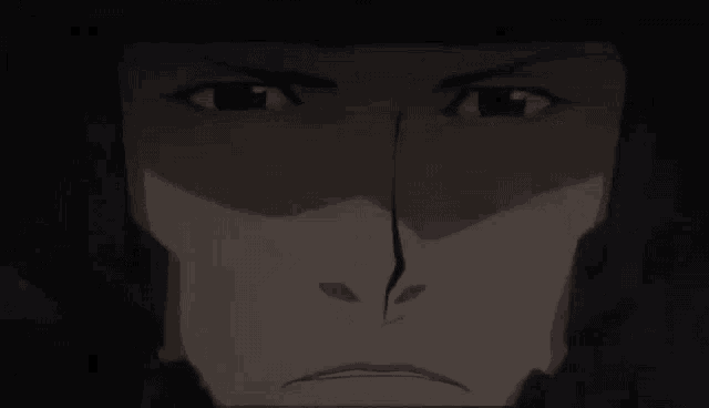 a close up of a man 's face in the dark with a crack in it .