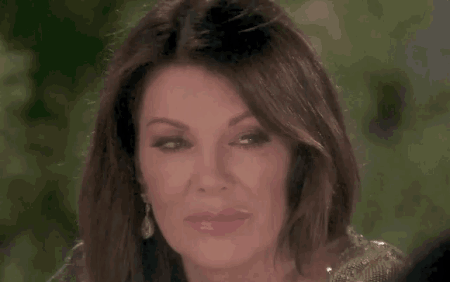 a close up of a woman 's face with her eyes closed