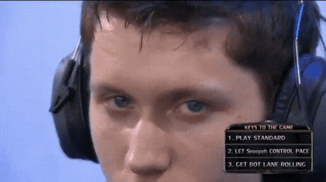a man wearing headphones looks at the keys to the game