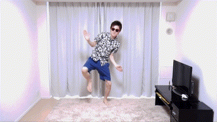a man is jumping in the air in a living room with a television in the background .