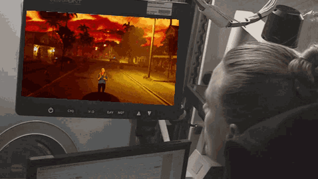 a woman is looking at a monitor that says viewpoint