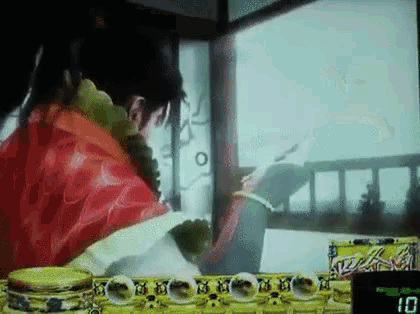 a man in a red robe is playing a video game with a score of 10 .