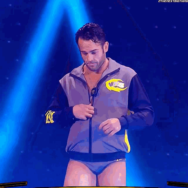 a man standing in front of a wwe trophy