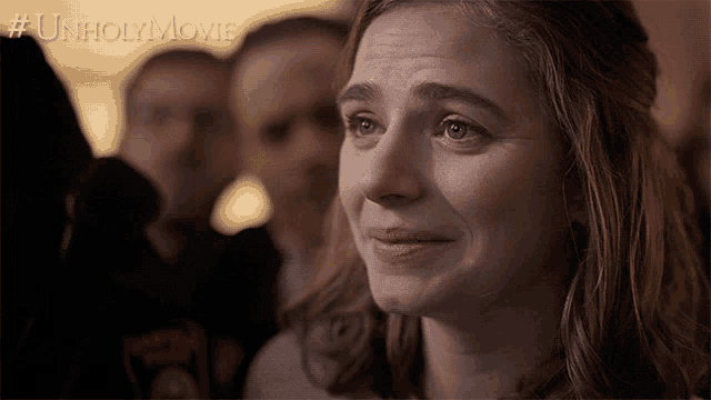 a woman is crying in front of a crowd with the hashtag unholymovie