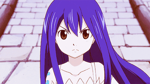 a girl with long blue hair and a tattoo on her arm