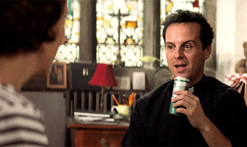 a man in a black shirt is holding a can of soda in his hand