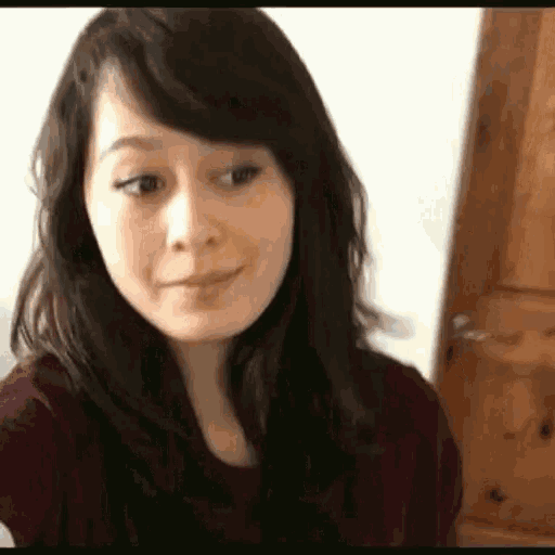 a woman is taking a selfie in front of a door .