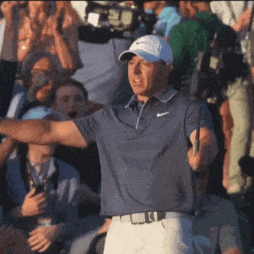 a man wearing a nike hat is holding a golf club