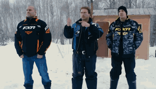 three men wearing jackets with the word fxr on them