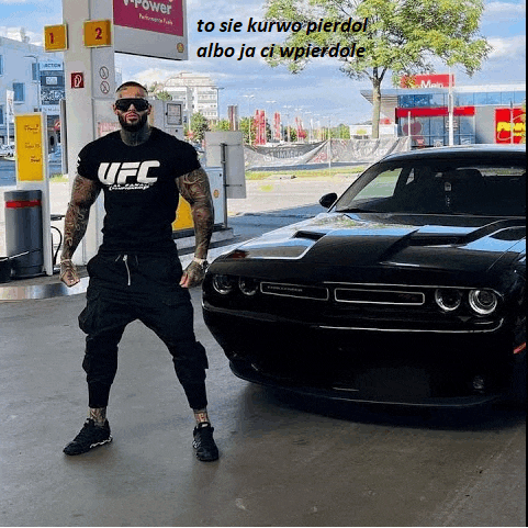 a man wearing a ufc shirt is standing in front of a car