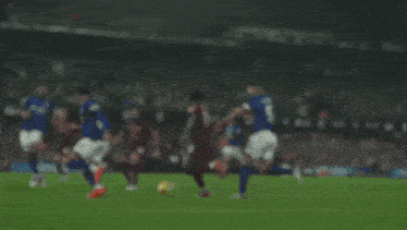 a soccer game is being played in front of an ad for fleximize.m