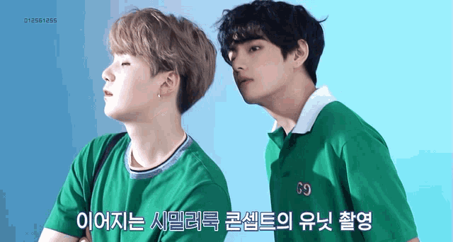 two young men wearing green shirts with the letters g9 on them