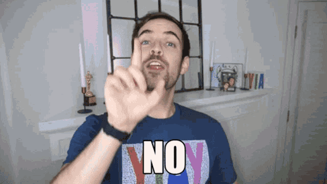 a man wearing a shirt that says " no " on it