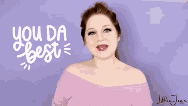 a woman stands in front of a purple background with the words " you da best " on it