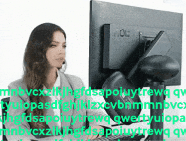 a woman sitting in front of an aoc computer monitor