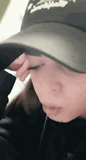 a close up of a woman wearing a hat that says ' swag ' on it