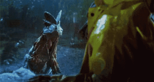 a close up of a dinosaur eating another dinosaur in a movie .