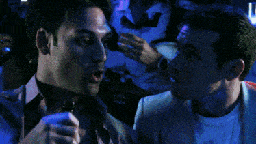 a man wearing a watch points at another man